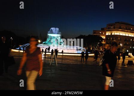 The life in the night street in Valletta near shining Tritons Fountain Stock Photo