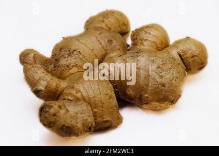 fresh ginger root on a white background in close up Stock Photo