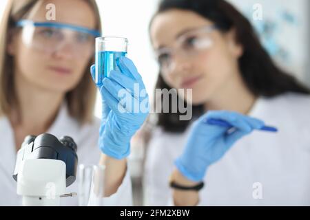 Two scientists are conducting experiments in laboratory Stock Photo