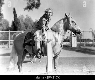 CAROLE LOMBARD 1937 candid portrait with her Palamino horse PICO on her ranch on the outskirts of Hollywood publicity for Paramount Pictures Stock Photo