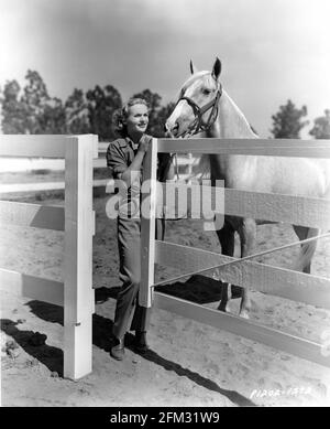 CAROLE LOMBARD 1937 candid portrait with her Palamino horse PICO on her ranch on the outskirts of Hollywood publicity for Paramount Pictures Stock Photo