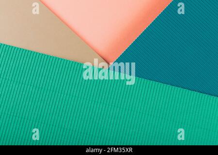 Green, pink and blue corrugated paper texture. Geometric shapes and lines. Minimalist background. Flat lay. Copy space. Stock Photo
