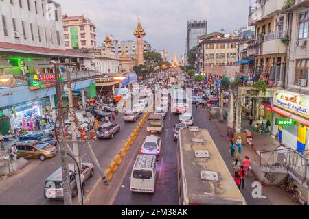 YANGON, MYANMAR - DECEMBER 15, 2016: Traffic on Mahabandoola Road leading to Sule Pagoda in Yangon. Stock Photo