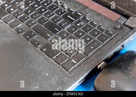 Close-up on dirty and unhygienic computer laptop keyboard, full of dust and particles Stock Photo