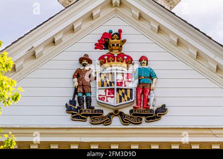 Close up isolated image of the reverse side of the official state Seal of Maryland depicting a fisherman and a plowman on sides of the coat of arms. T Stock Photo