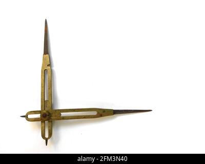 Old brass reduction compass or proportional scale divider. Geometry tool used to scale designs. Stock Photo