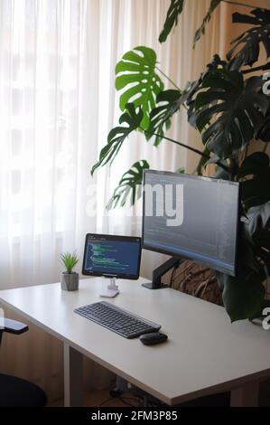 Work place for developer with curved screen and tablet.Comfort working from home Stock Photo