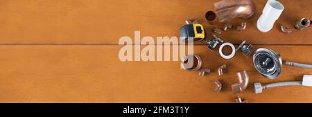 Different Plumbers tools and fittings on wood background. Copy space text. Selective focus. Stock Photo