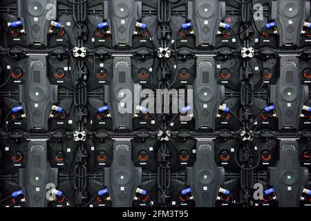 Wall of LED monitors, backside or rear view, cables, connections, modern technology system Stock Photo
