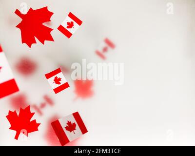 July 1, Happy Canada Day. Red maple leaves and flags on a transparent foggy background. A multi-tiered photo, a Memorial day card. The concept of free Stock Photo