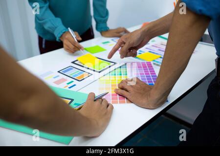 team designers Presentation model mobile phone screen to suit their usage.UX UI and Programming Stock Photo
