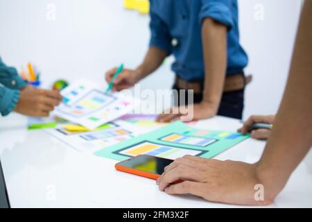 team designers Presentation model mobile phone screen to suit their usage.UX UI and Programming Stock Photo