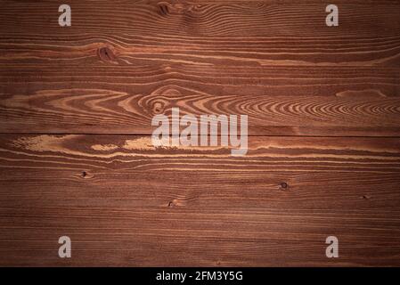 Dark wooden table or tabletop as texture or background. Top view of an empty wooden desk texture. Stock Photo