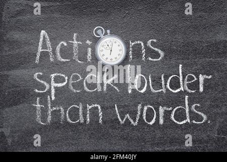 Actions speak louder than words saying written on chalkboard with vintage precise stopwatch Stock Photo