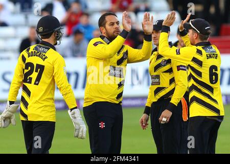 Kieran Noema-Barnett of Gloucestershire (C) is congratulated by his team mates after taking the wicket of Ravi Bopara during Essex Eagles vs Glouceste Stock Photo