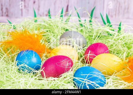 Colorful painted Easter eggs decorations on light green background. Stock Photo