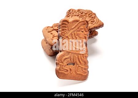 Speculoos or Spekulatius, traditional almond biscuits in a stack on a white background Stock Photo