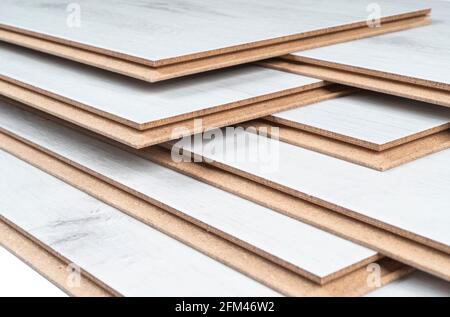 A stack of laminate flooring. Laminate flooring panels background texture. Laminate background. Wooden laminate and parquet boards for the floor Stock Photo