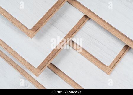 A stack of laminate flooring. Laminate flooring panels background texture. Laminate background. Wooden laminate and parquet boards for the floor i Stock Photo