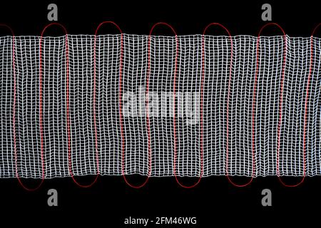 Heated floor isolated on black background. Underfloor electric heating. Warm floor system texture. Mat electric floor heating system. Stock Photo
