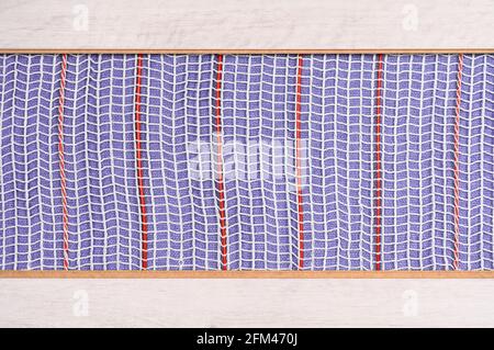 Heated floor under laminate background. Underfloor electric heating. Warm floor system texture. Mat electric floor heating system. Stock Photo
