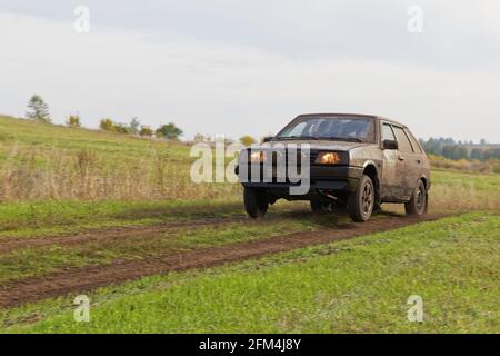 Ulyanovsk, Russia - September 24, 2016. Rally raid 'Hills of Russia'. Dirty sports car racing on the road among fields. Stock Photo