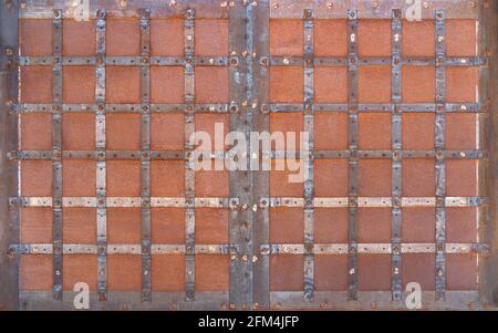 Old rusted opaque metal gate with a square pattern Stock Photo