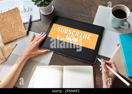 Subscribe button on device screen. Internet and digital marketing concept Stock Photo