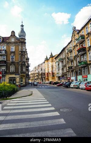 POZNAN, POLAND - Oct 18, 2015: Zebra crossing leading to street with parked cars and building at the Lazarski area Stock Photo
