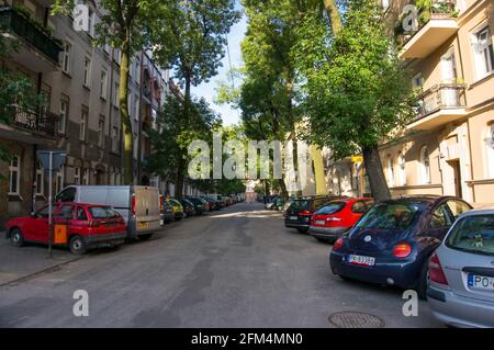 POZNAN, POLAND - Oct 18, 2015: Parked cars by buildings on the Mottego street Stock Photo