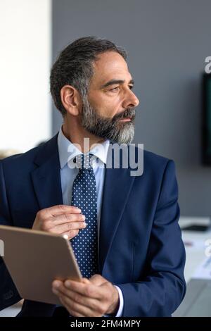 Portrait of senior businessman using tablet in his modern office Stock Photo
