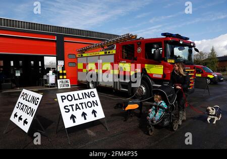 Wigston, Leicestershire, UK. 6th May 2021. A woman walks past the Polling Station at Wigston Fire Station during the local elections. Millions of people across Britain will cast a ballot on Thursday in the biggest set of votes since the 2019 general election.  Credit Darren Staples/Alamy Live News. Stock Photo