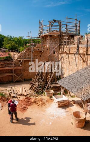 Medieval construction site of the castle of Guedelon with a treadwheel winch, Yonne (89), Treigny, Bourgogne-Franche-Comte region, France Stock Photo