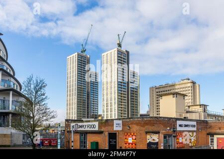 Newly completed tall tower block buildings in Victoria Square towering over the skyline of the town centre of Woking, Surrey seen from the station Stock Photo