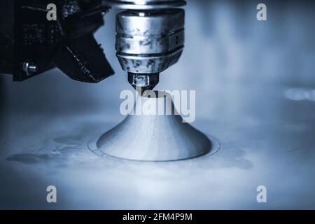 Modern 3D printer printing figure close-up. Dark. Copy space. Stock Photo