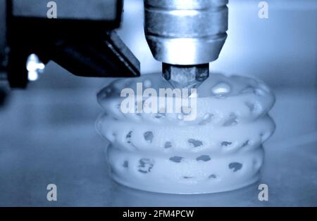3d printer printing objects blue gray color form closeup. Stock Photo