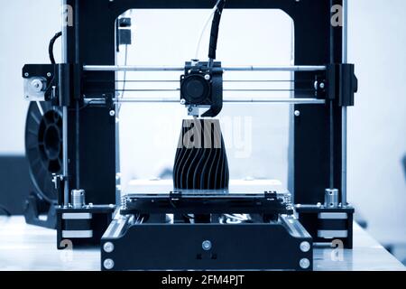 The process of working 3D printer and creating a three-dimensional object Stock Photo