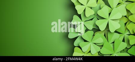 Cloverleaf background isolated on a green background to the left. All clovers are four-leafed. Spring or luck concept. Web banner format. Stock Photo