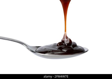 Spoon with thick brown oyster sauce close up  isolated on white background Stock Photo