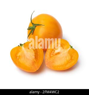 Whole and halved ripe yellow roma tomato close up isolated on white background Stock Photo