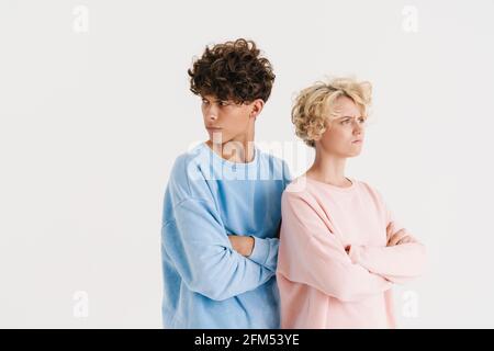 Image of offended young loving couple isolated over white background Stock Photo