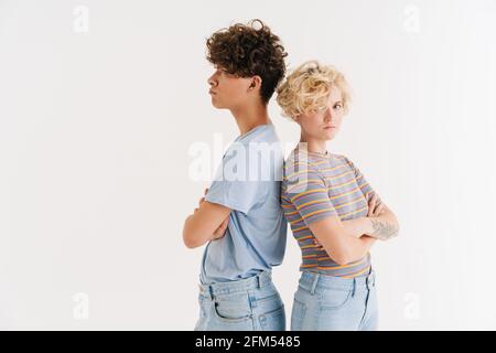 Image of offended displeased young loving couple isolated over white background Stock Photo