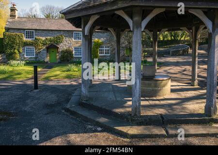 The old market stand with the Sheepwash Bridge behind, Ashford-in-the-Water, near Bakewell, Peak District National Park, Derbyshire Stock Photo