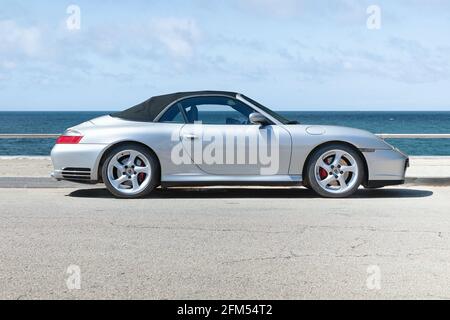 BARCELONA, SPAIN-APRIL 12, 2021: 2005 Porsche 911 (997) Carrera 4S Cabriolet (side view) parked by the sea Stock Photo