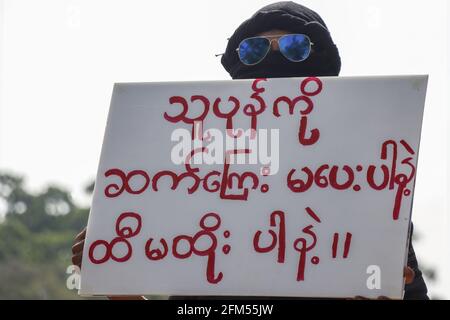 An anti-military coup protester holds a placard reading “Don't give tax to the rebel” during a peaceful demonstration against the military coup.A massive crowd took to the streets of Lashio to protest against the military coup and demanded the release of Aung San Suu Kyi. Myanmar's military detained State Counsellor of Myanmar Aung San Suu Kyi on February 01, 2021 and declared a state of emergency while seizing the power in the country for a year after losing the election against the National League for Democracy (NLD). (Photo by Mine Smine/SOPA Images/Sipa USA) Stock Photo