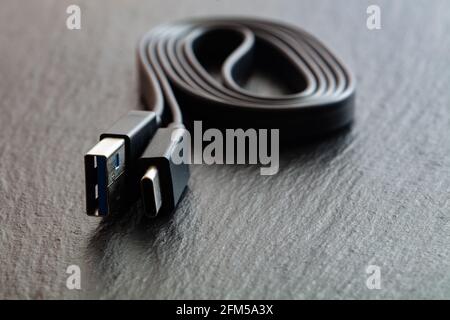 Black USB Type-C cord on black background for design purpose Stock Photo
