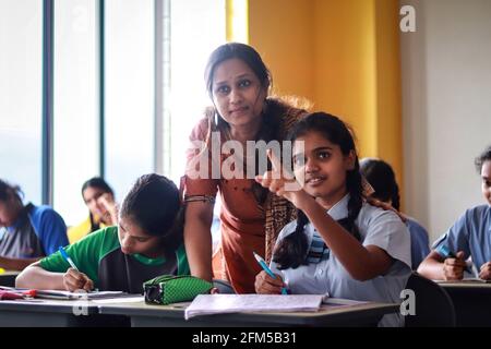 teacher interacting with students Stock Photo