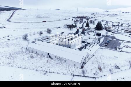 Dalwhinnie, Scotland, UK. 6 May 2021. Aerial view of snow covered landscape in the high altitude Drumochter Pass at Dalwhinnie in the Scottish highlands. Pic; Dalwhinnie scotch whisky distillery in a snow covered landscape.  Iain Masterton/Alamy Live News Stock Photo