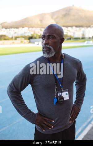 African american male coach with hands on hips standing in the stadium Stock Photo