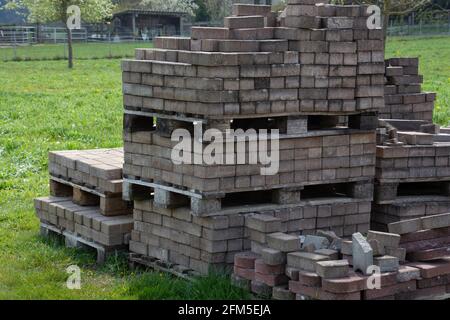 different concrete blocks stacked on a wooden pallet stored in the garden Stock Photo